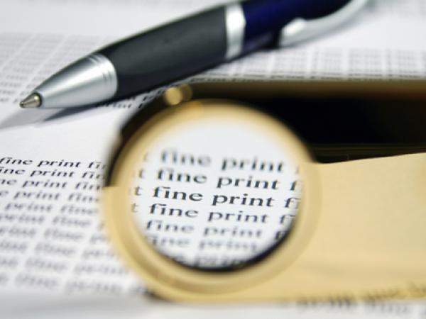Pen and Magnifyihng Glass with text saying "Fine Print"