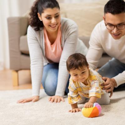 Parents playing on the ground with their child