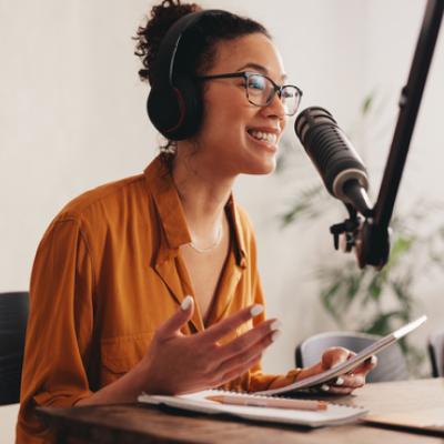 Girl speaking into podcast microphone