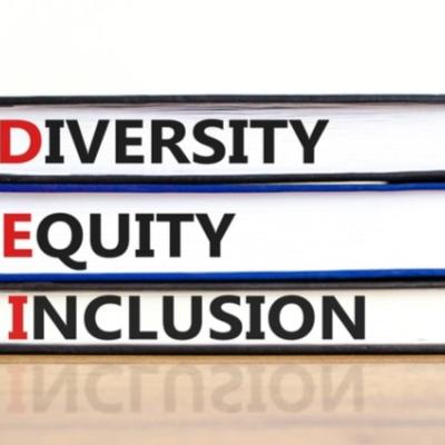 Diversity Equity Inclusion written on spine of three stacked books