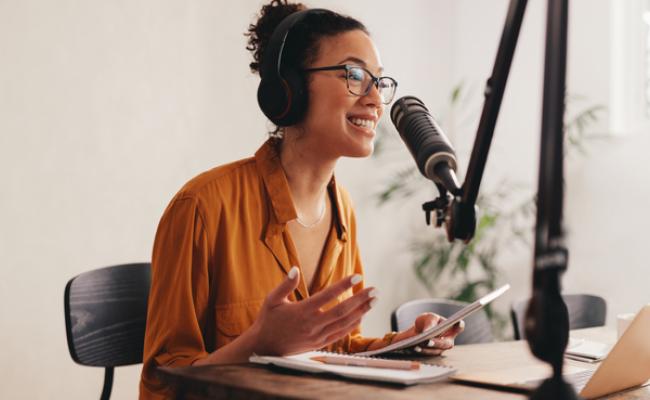 Girl speaking into podcast microphone