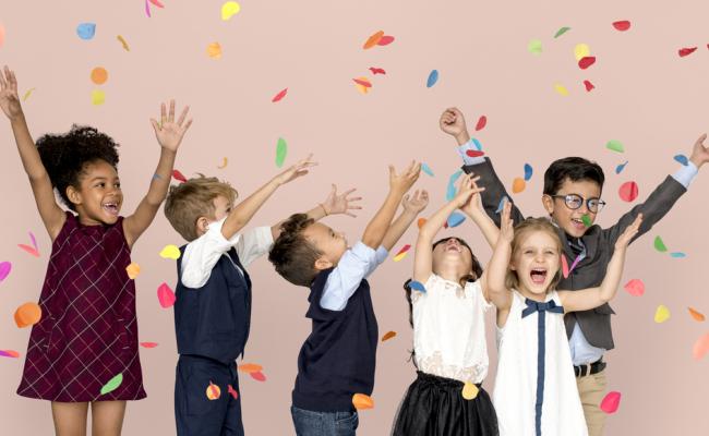 kids with arms in air and confetti