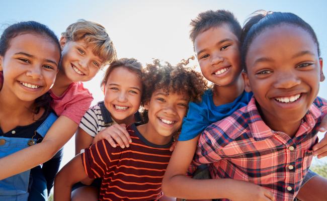 Diverse kids huddled together